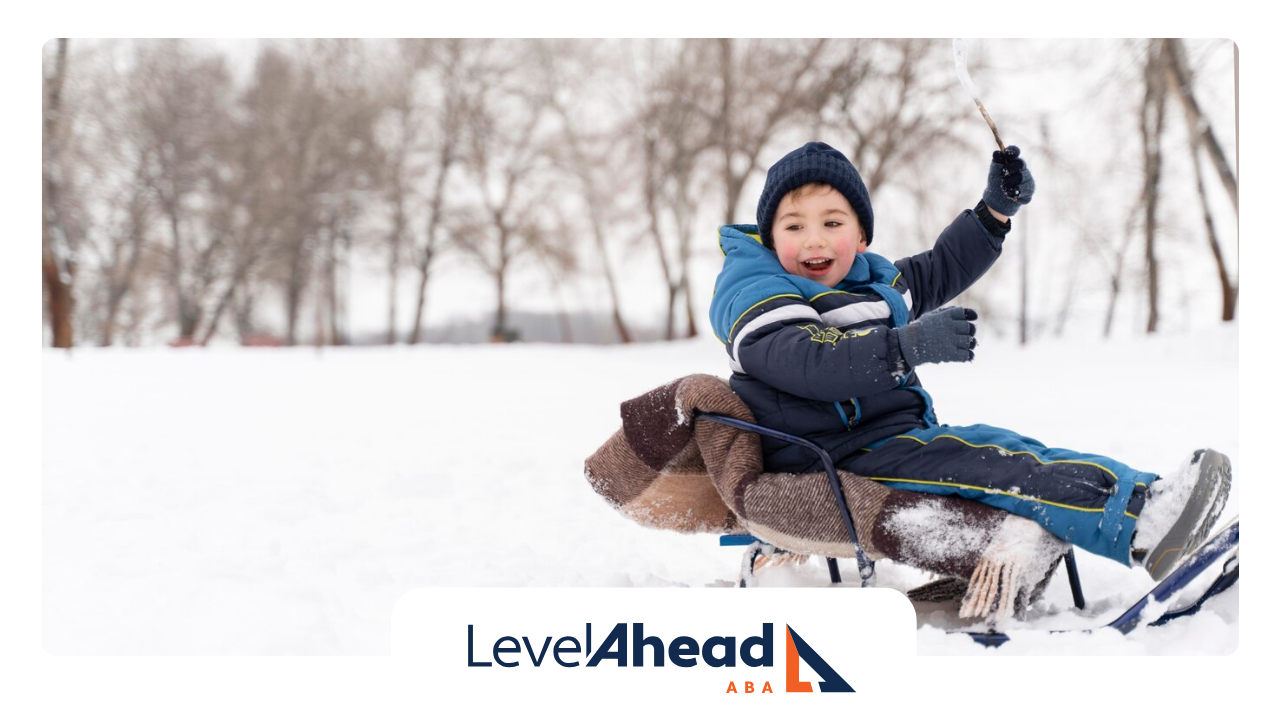 An autistic child on a sled in the snow