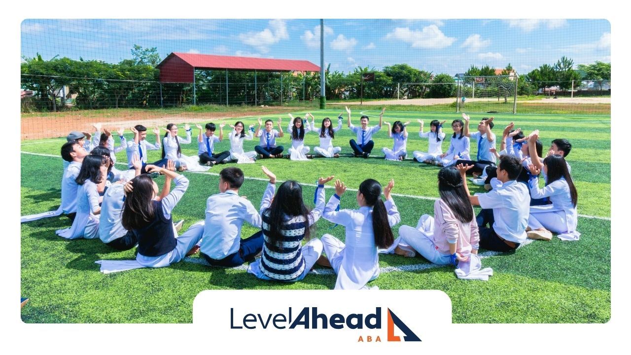 Autistic students sitting in a circle outdoors on a field, engaging in an activity in Nebraska.