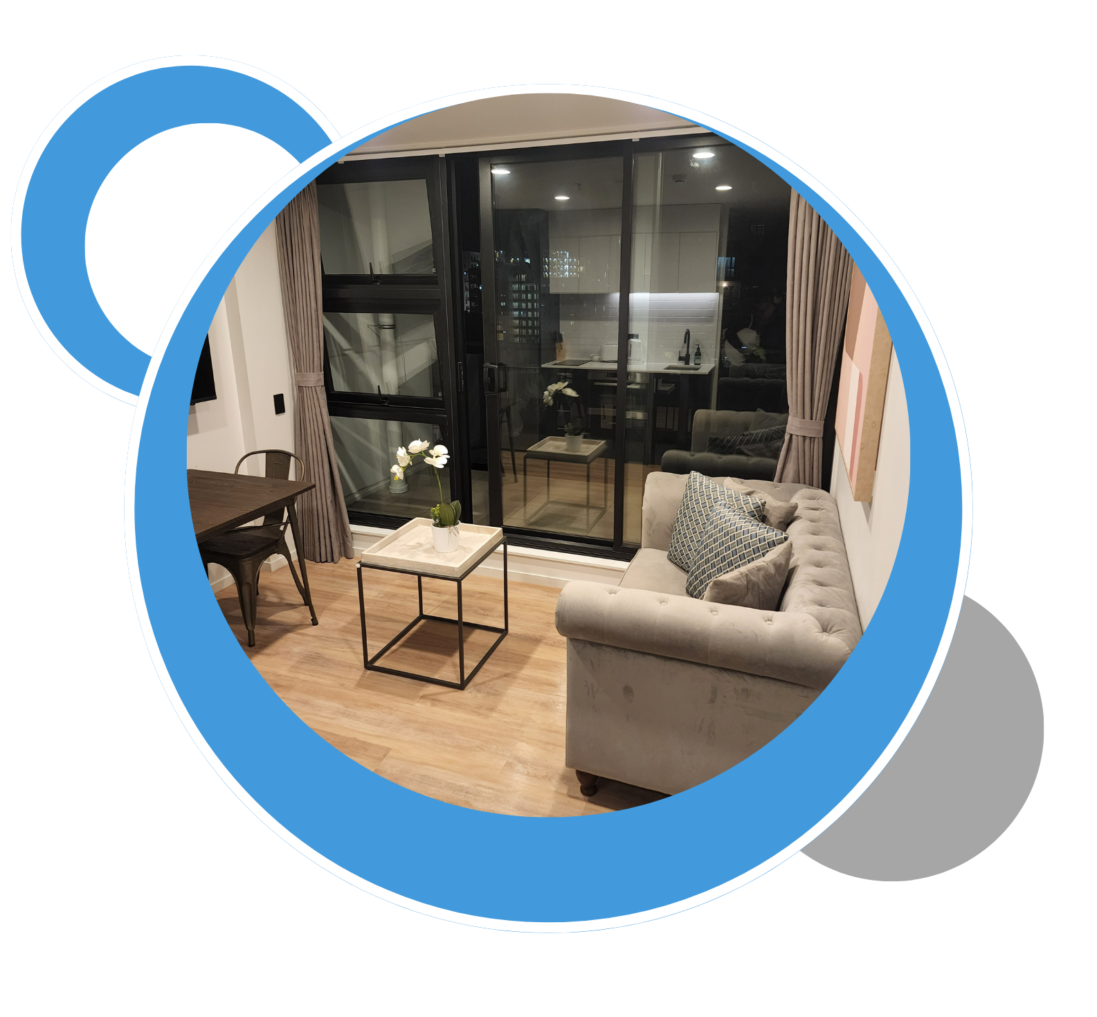 A living room with a couch , table , chairs and a large window. A living room with a couch , table , chairs and a large window.