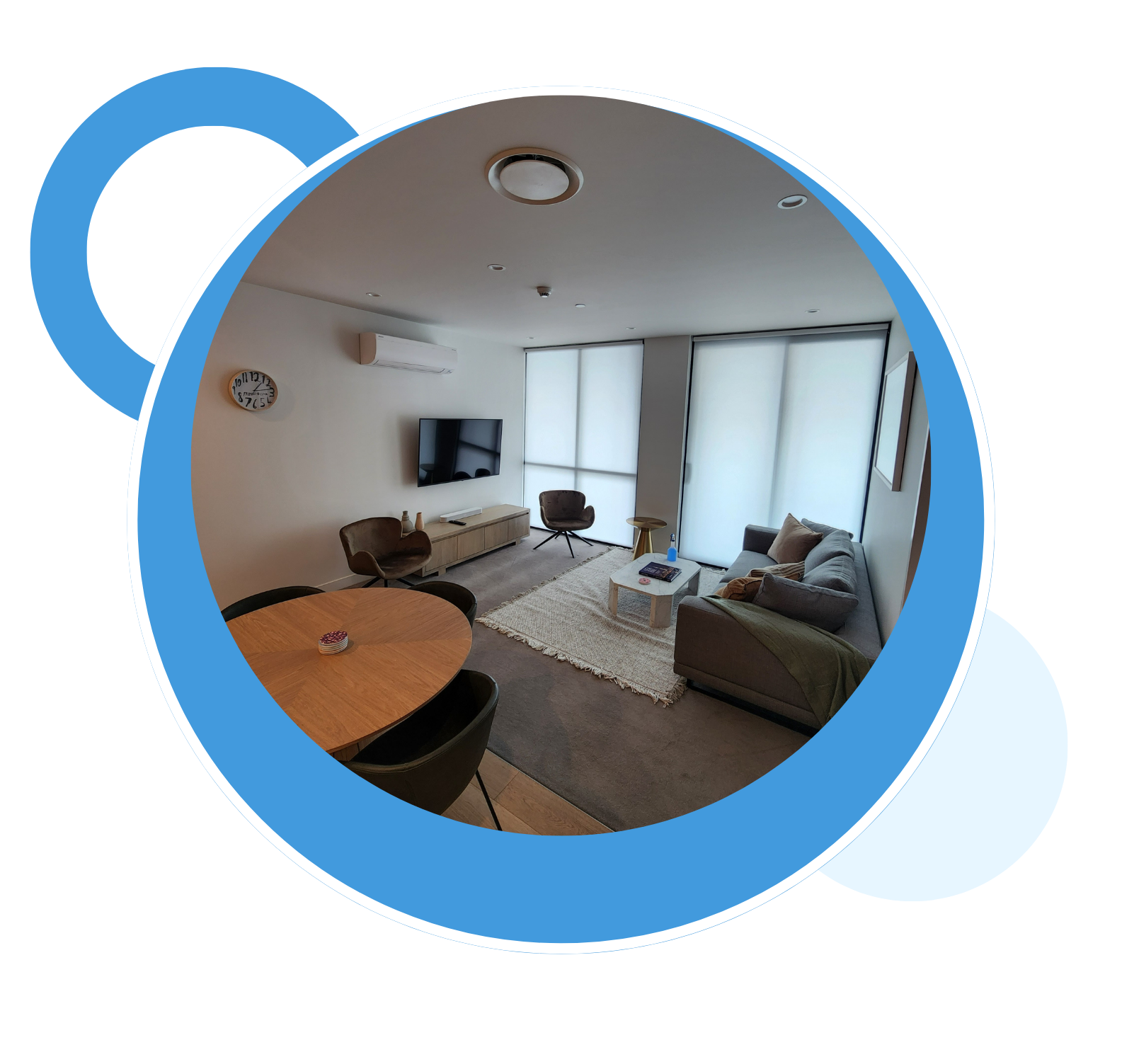 A living room with a couch , table , chairs and a flat screen tv.
