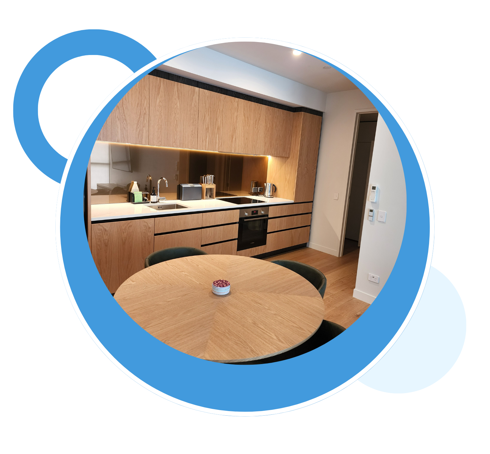 A kitchen with wooden cabinets and a round table