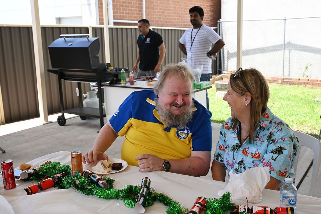 A man and a woman are sitting at a table with christmas decorations on it.