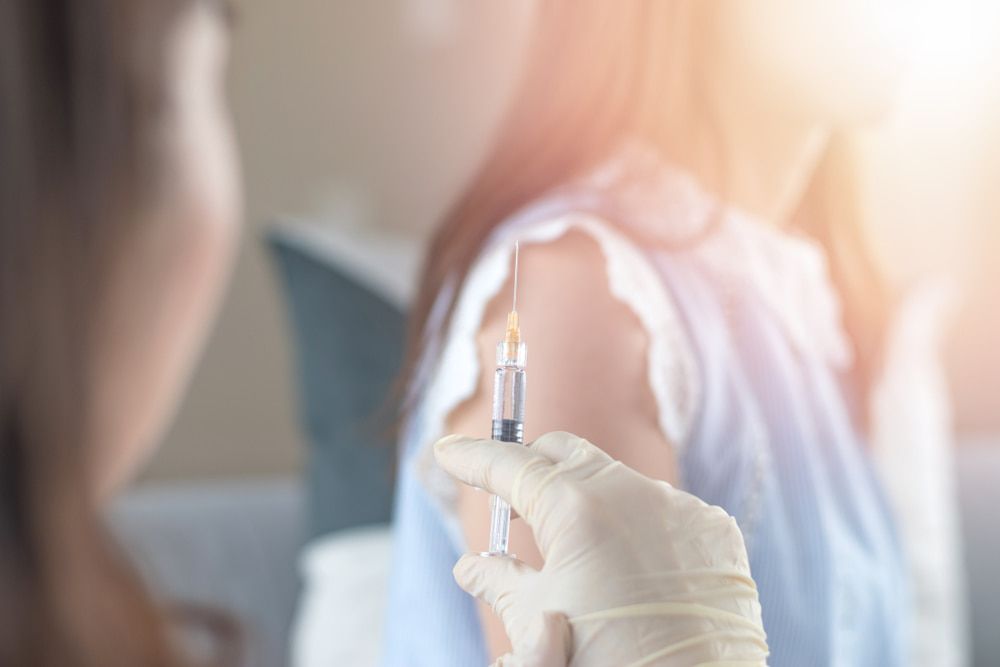 A Woman Is Getting an Injection in Her Arm — Health Hub Mackay in Mackay, QLD