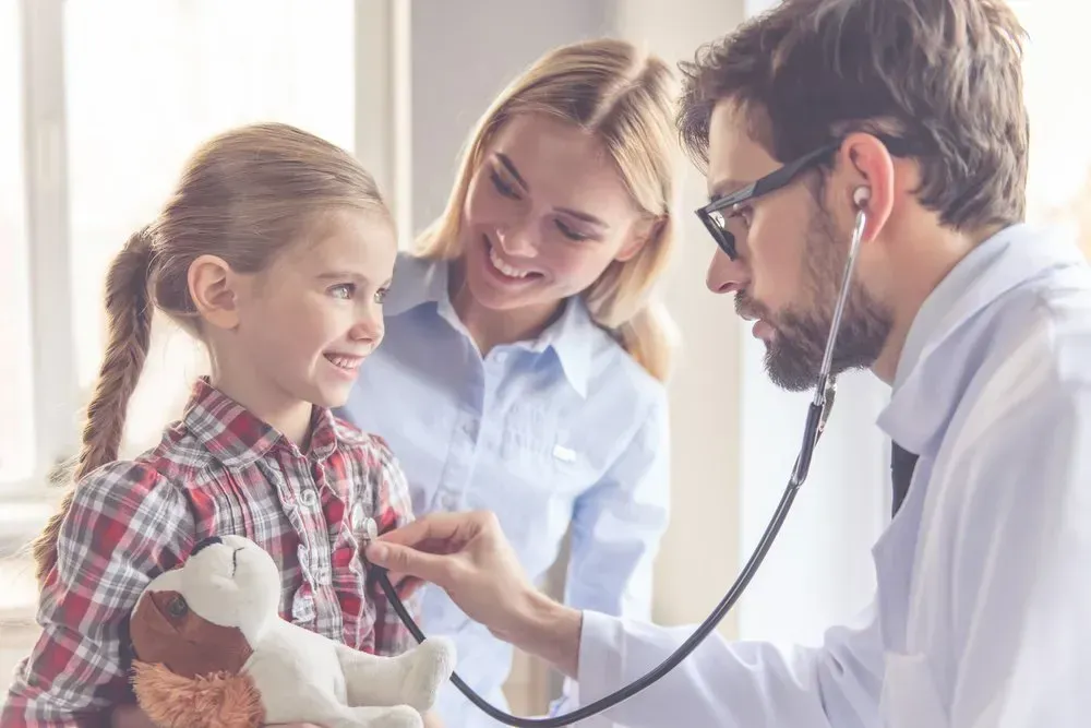 A Doctor Is Listening to A Little Girl 's Heart with A Stethoscope — Health Hub Mackay in Mackay, QLD