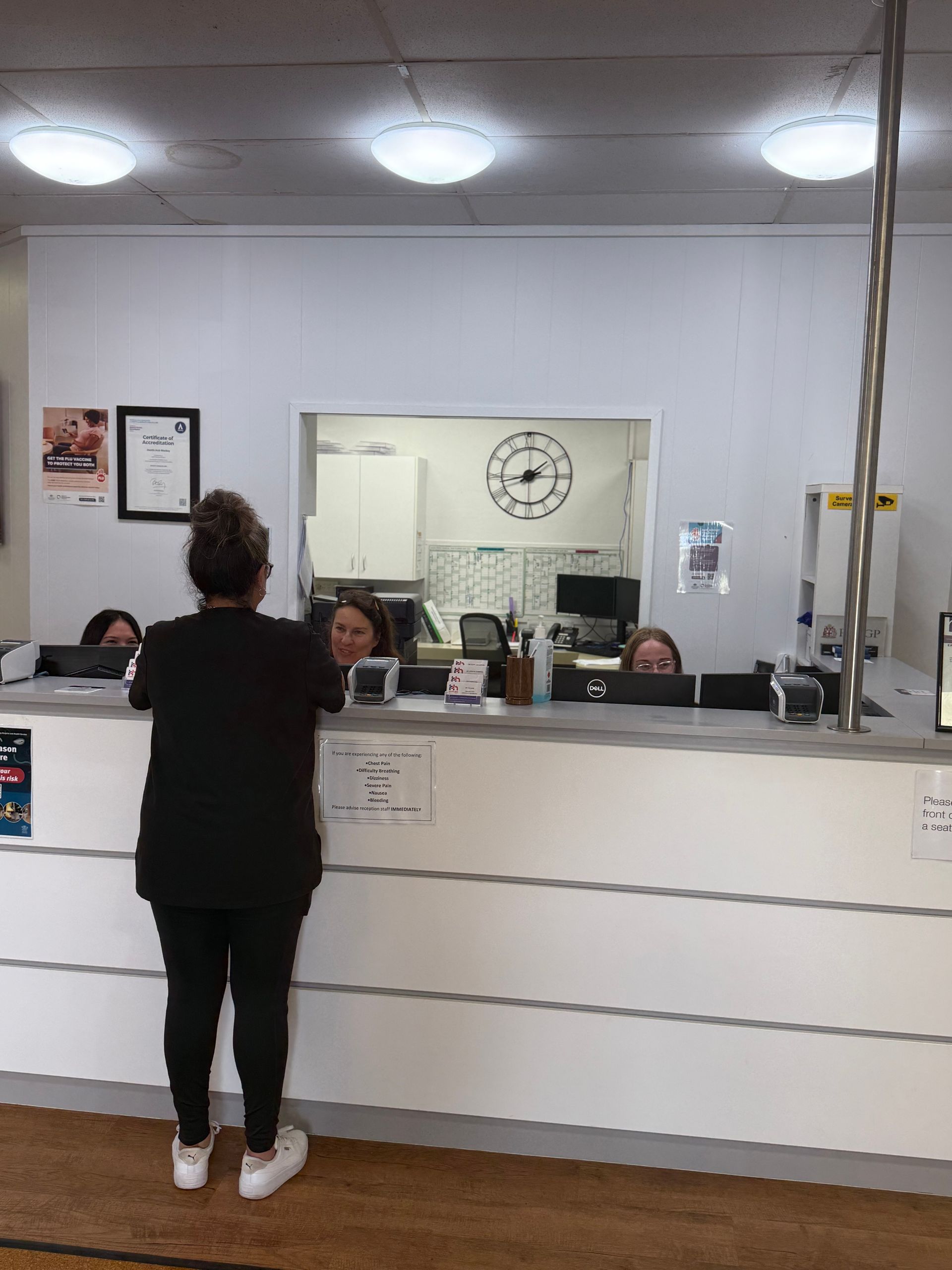 A Close Up Of A Person 's Back With A Doctor Examining It — Health Hub Mackay In North Mackay, QLD
