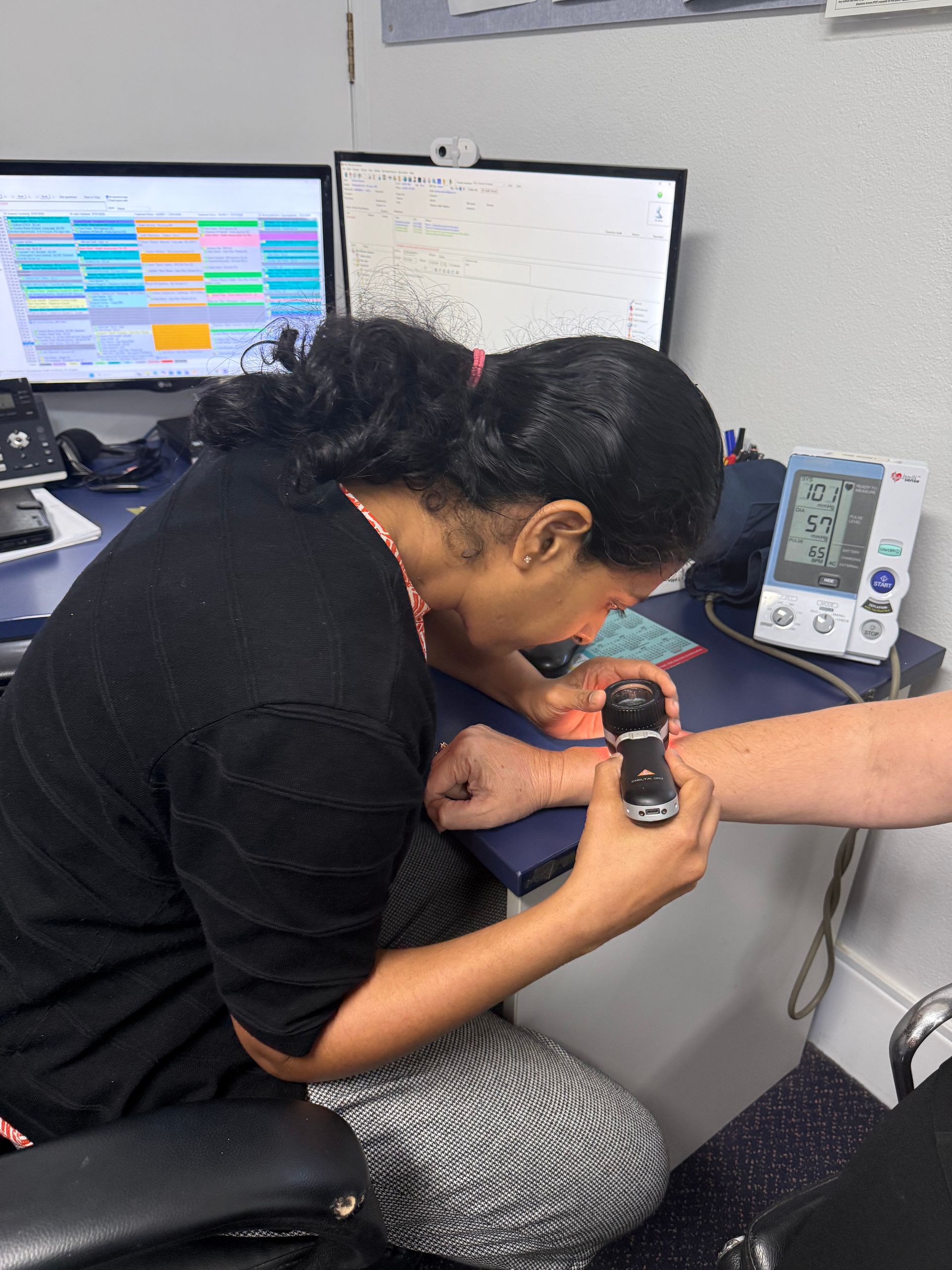 A Smiling Doctor with His Arms Crossed in Front of Two Nurses — Health Hub Mackay in Mackay, QLD