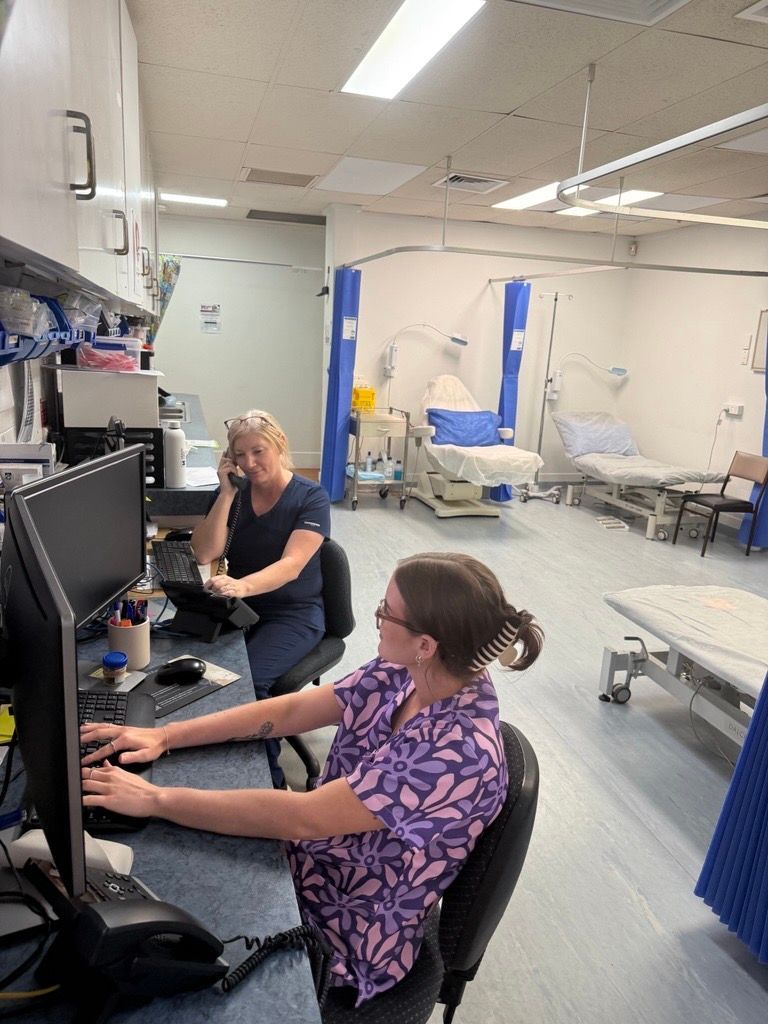 A Family Is Laying on A Couch and Smiling for The Camera — Health Hub Mackay in Mackay, QLD