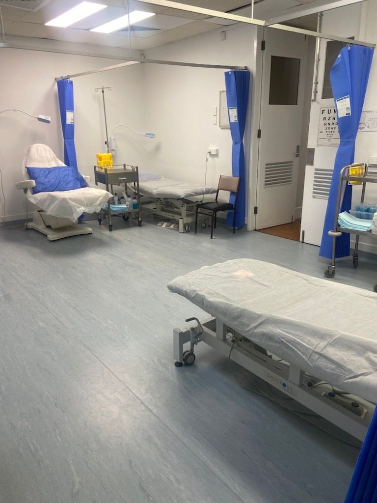 A Man in A Blue Shirt Is Smiling and Giving a Thumbs Up — Health Hub Mackay in Mackay, QLD