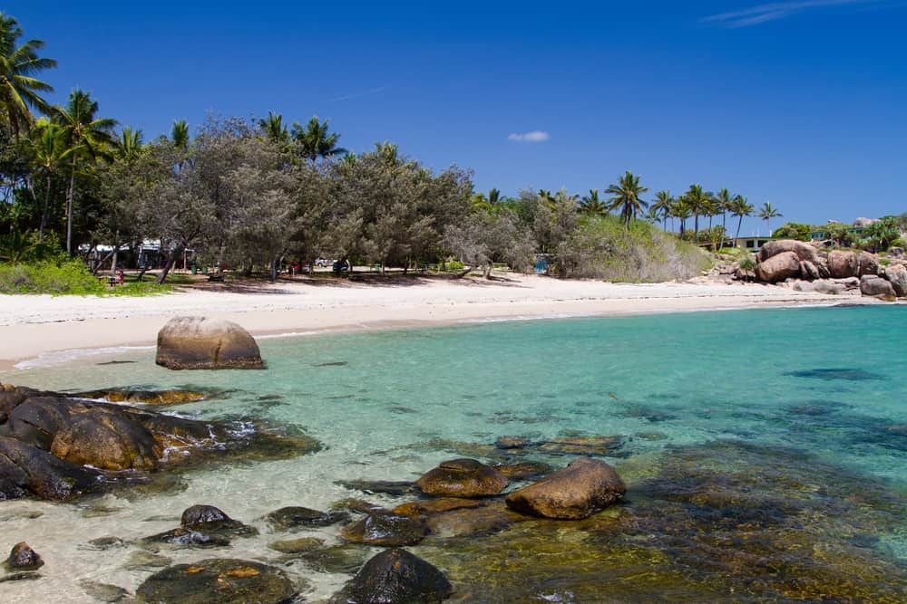 A Beach With A Lot Of Rocks And Trees In The Background — Health Hub Mackay In Bowen, QLD