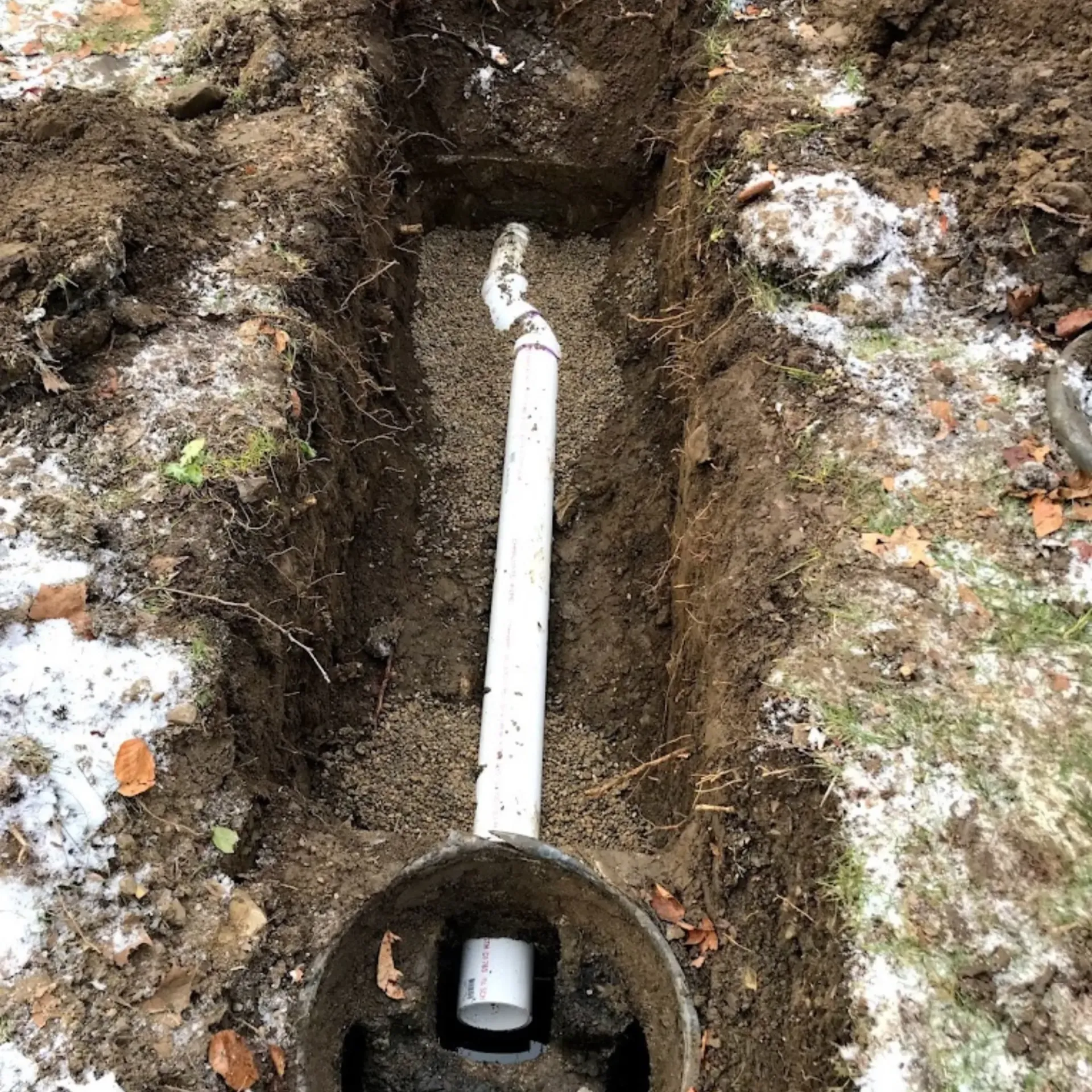 Affordable Waste Services - A pipe is being installed in a hole in the ground.