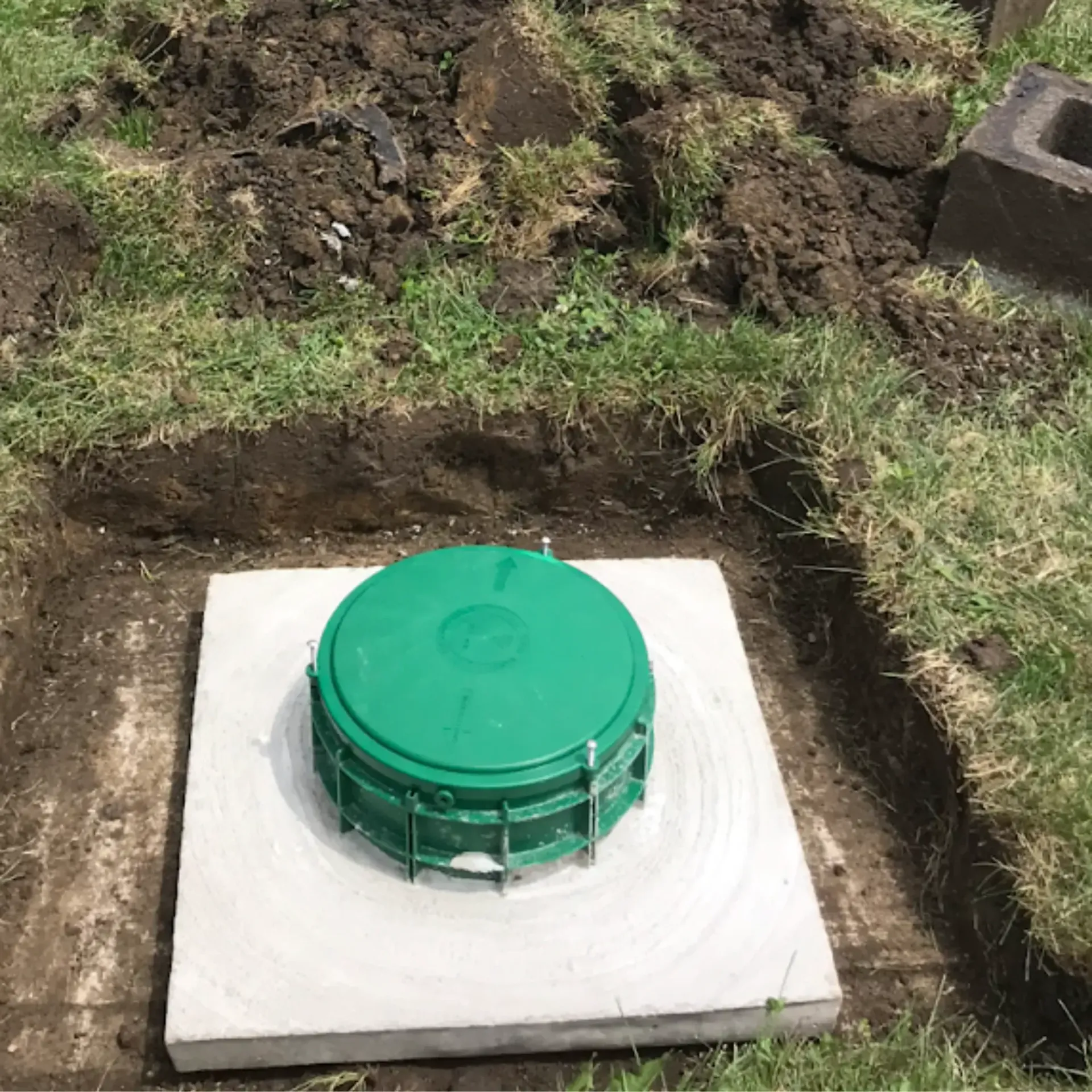 Affordable Waste Services - A green container is sitting on top of a concrete slab.