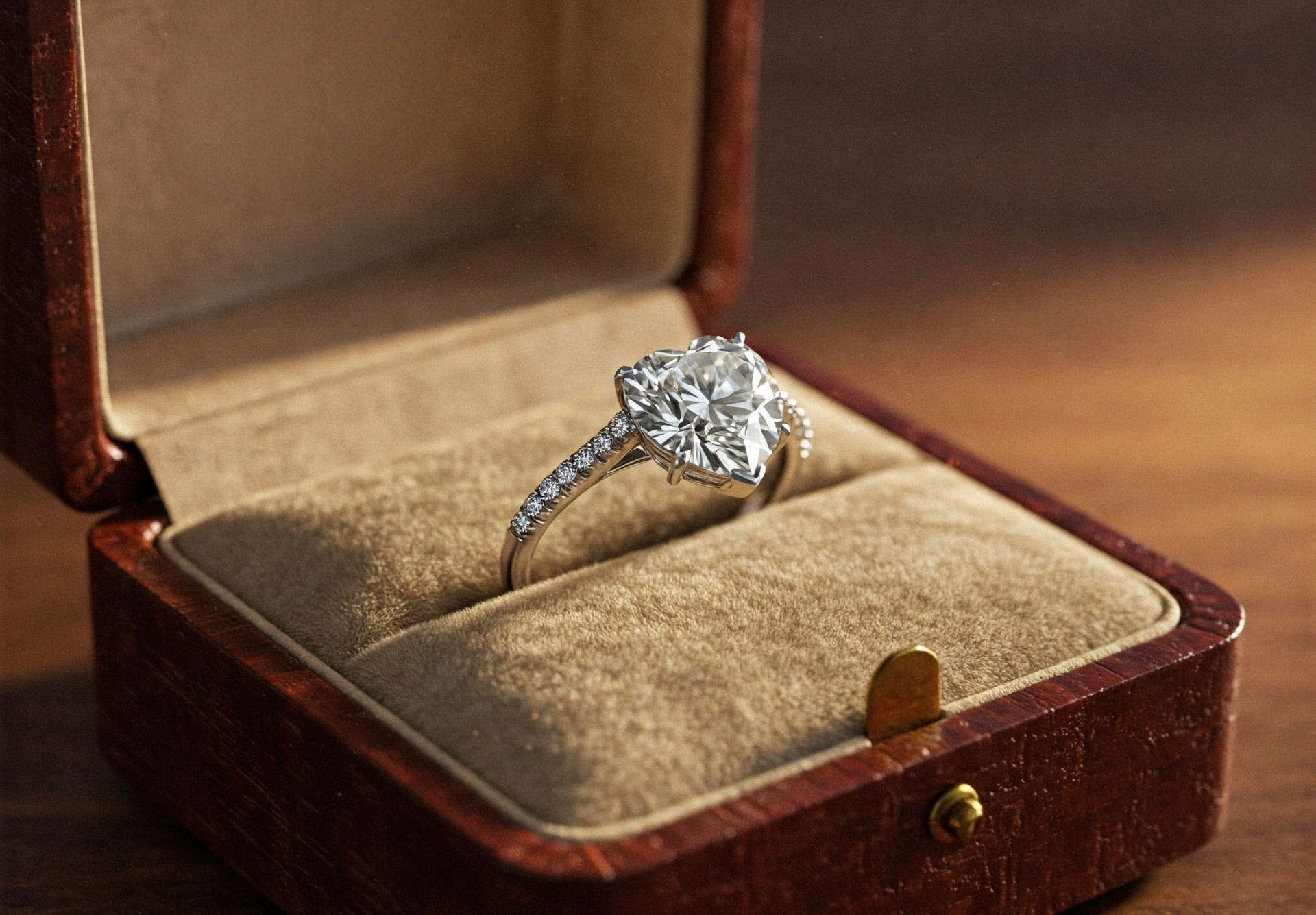 Diamond engagement ring and diamond-studded wedding band on a light surface.