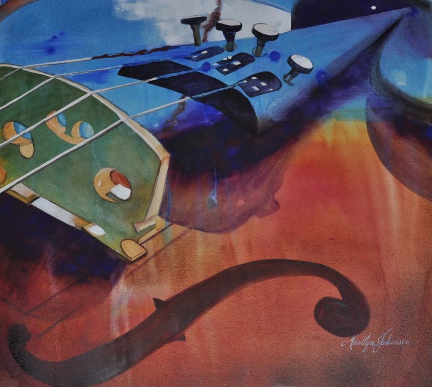 Blue and green guitar with an orange-red background; Eiffel Tower in the distance.