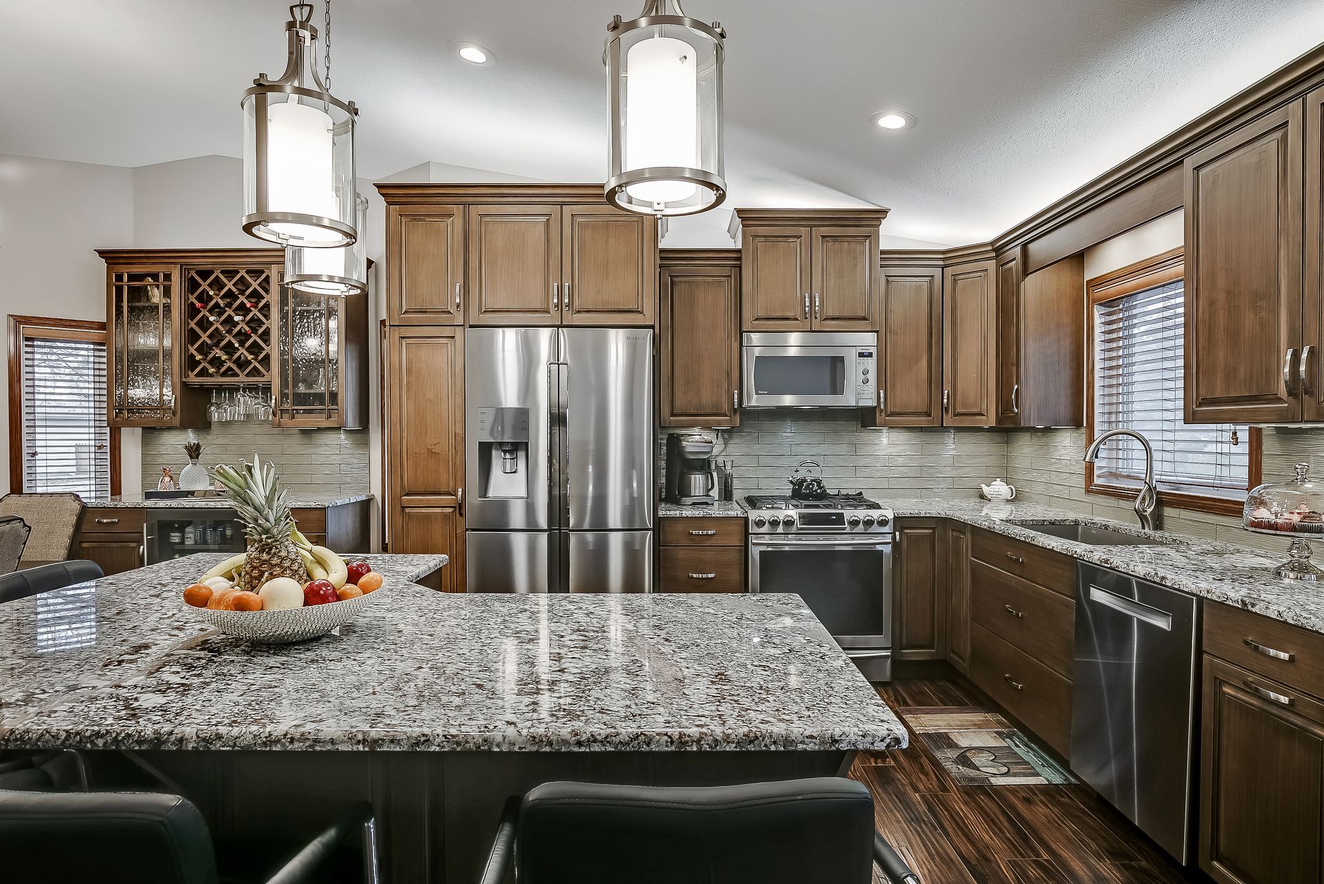 A large kitchen with a large island and stools.