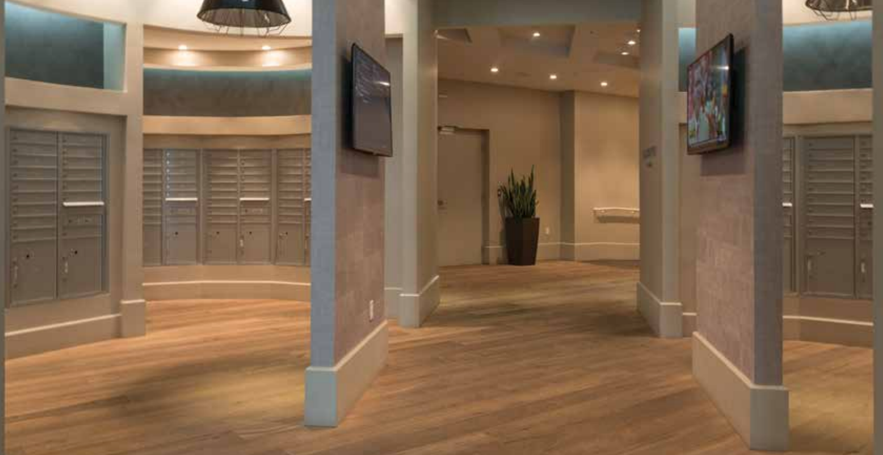 A hallway with wooden floors and a tv on the wall.