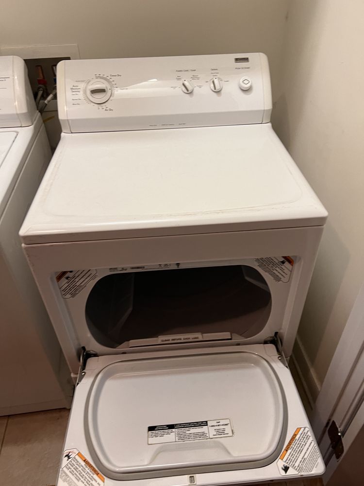 A white washer and dryer in a laundry room with the door open.