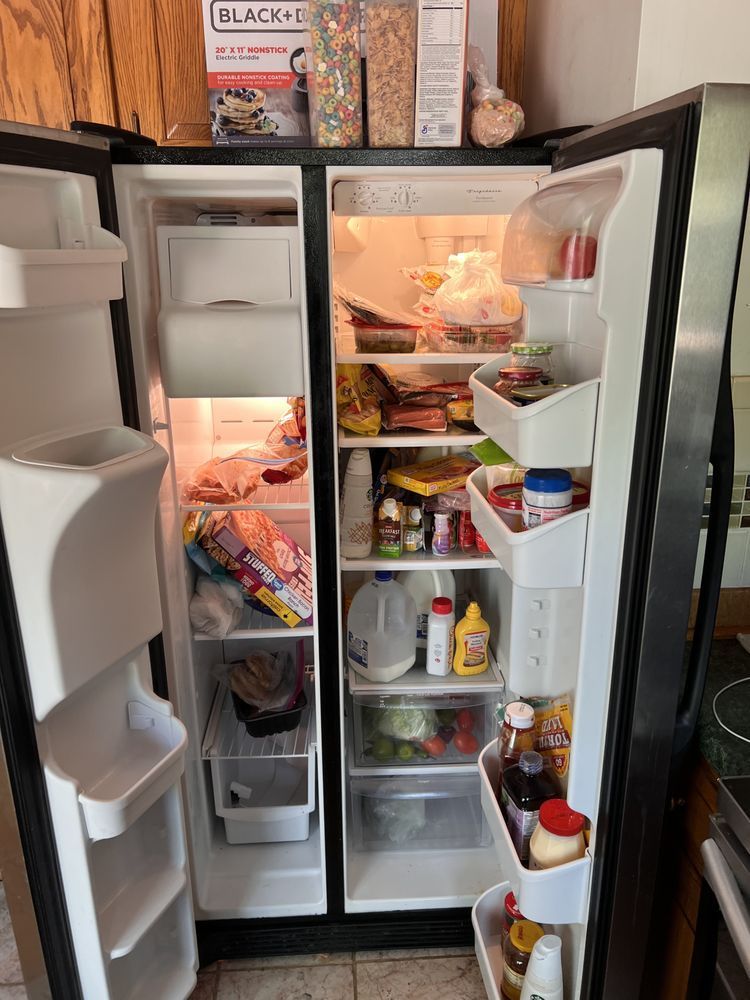 A refrigerator filled with lots of food and drinks in a kitchen.