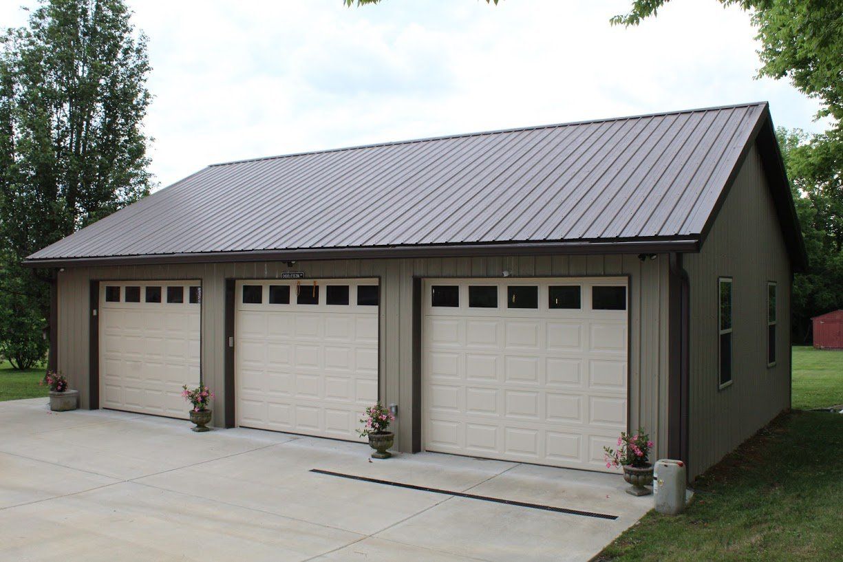 Light grey garage with three white doors