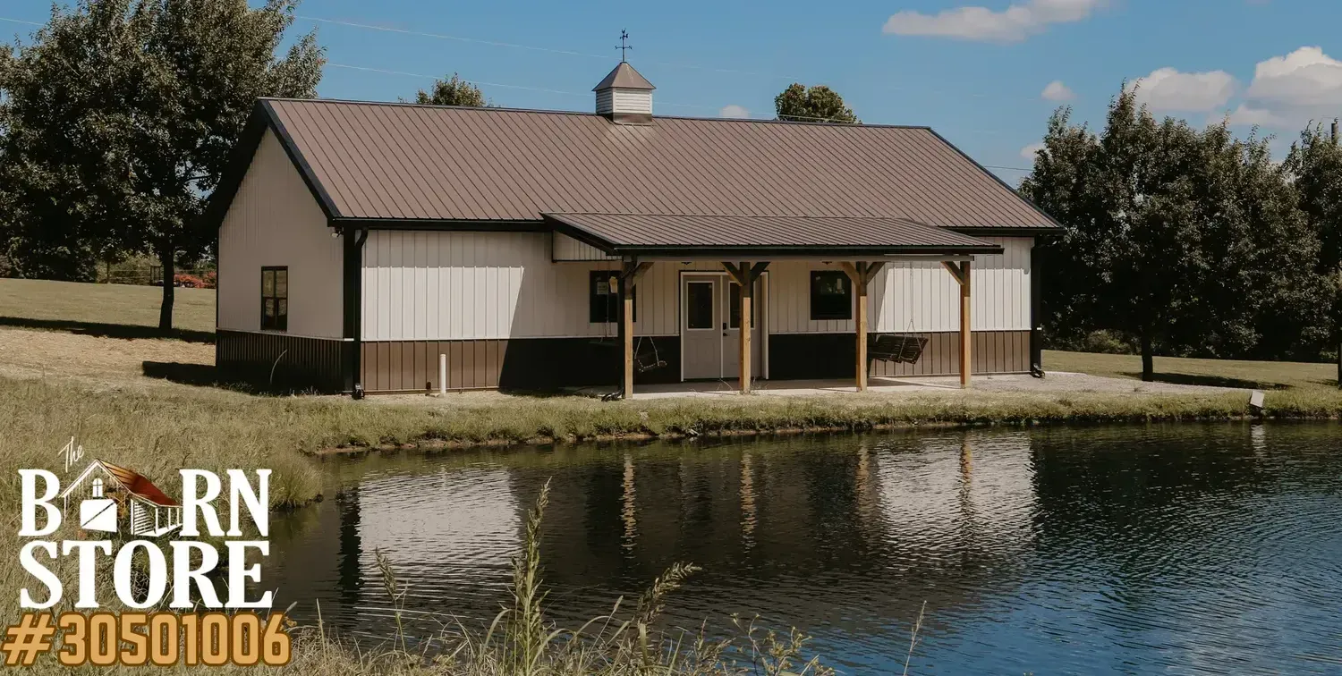 A picturesque white and brown barn with a metal roof, nestled beside a tranquil pond.