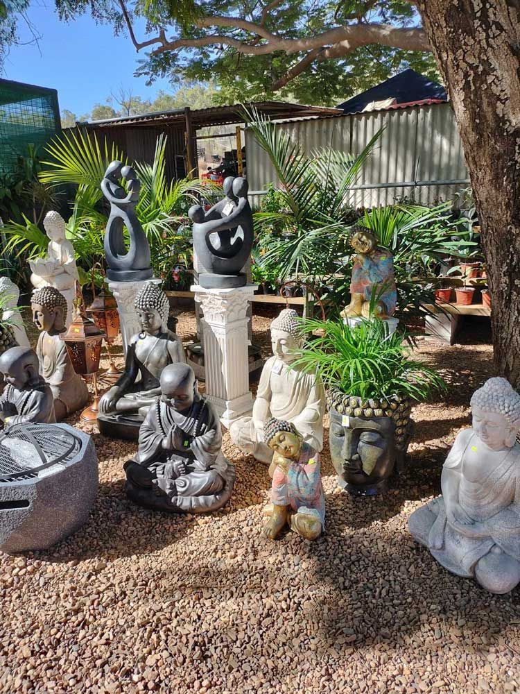 A Bunch of Statues Are Sitting Under a Tree in a Garden — Leichhardt River Nursery & Skip Bin Hire In Kalkadoon, QLD