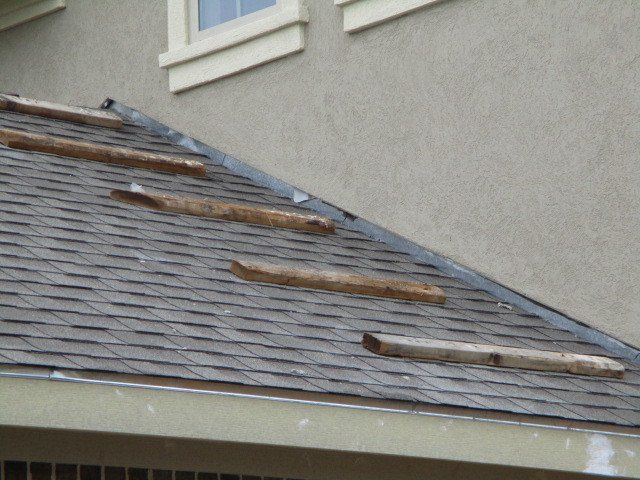 Toe boards nailed into new shingles. Each damaged shingle should be replaced.