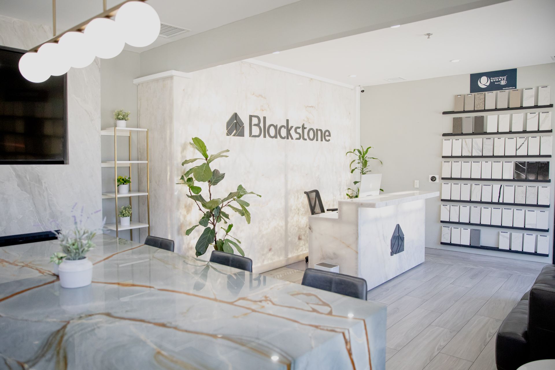 A room with a table, chairs, shelves and a sign that says blackstone.