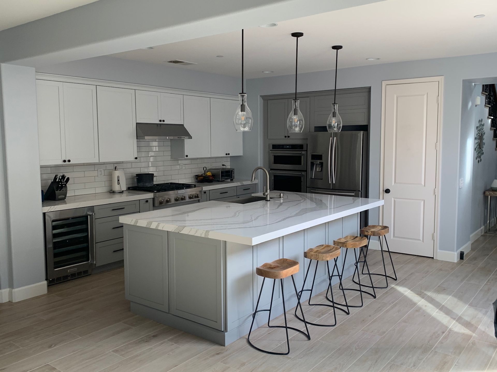A kitchen with a large island and stools