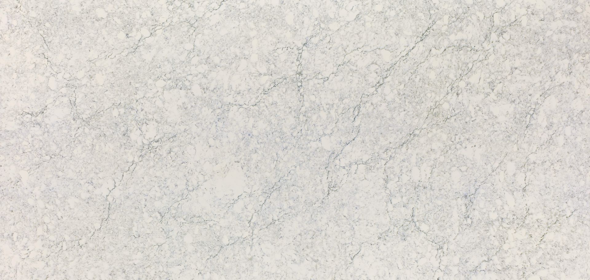 A close up of a white granite counter top.