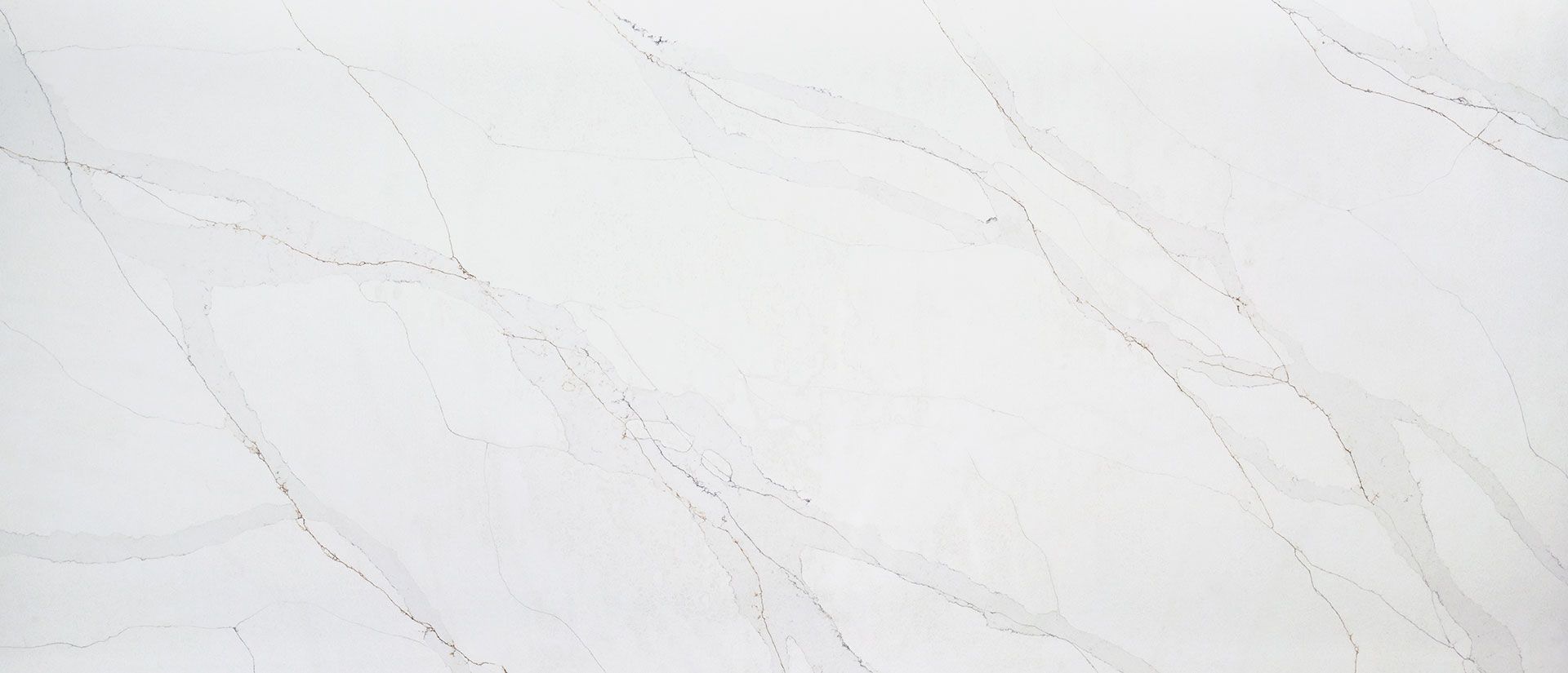 A close up of a white marble counter top.