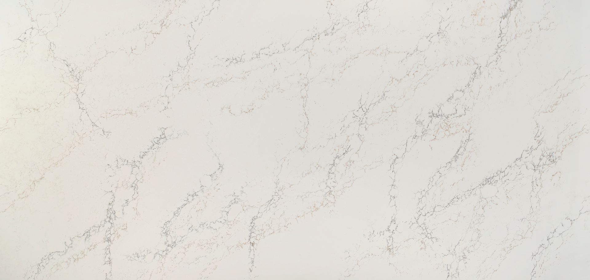 A close up of a white quartz counter top with a marble texture.