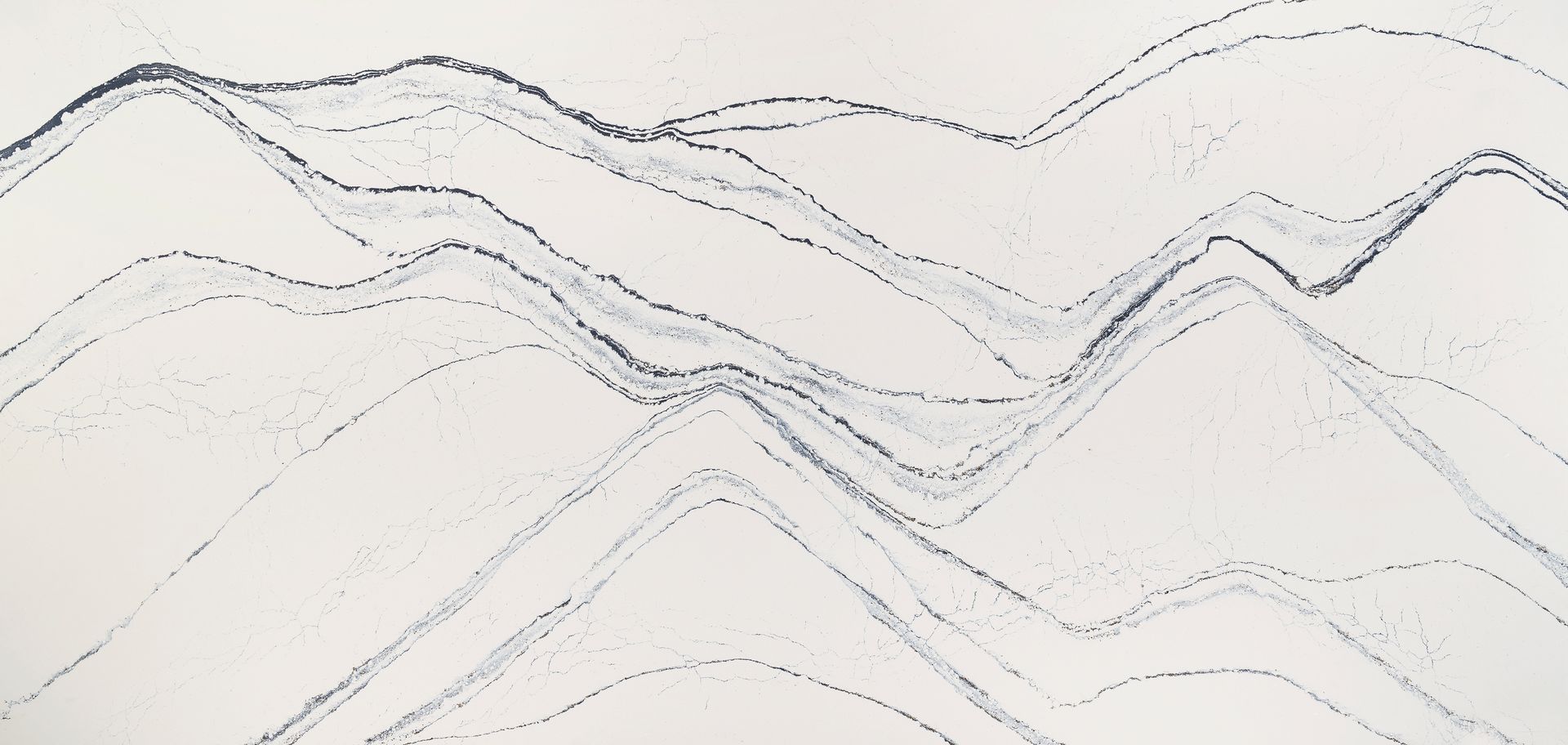 A close up of a white granite counter top with black lines.