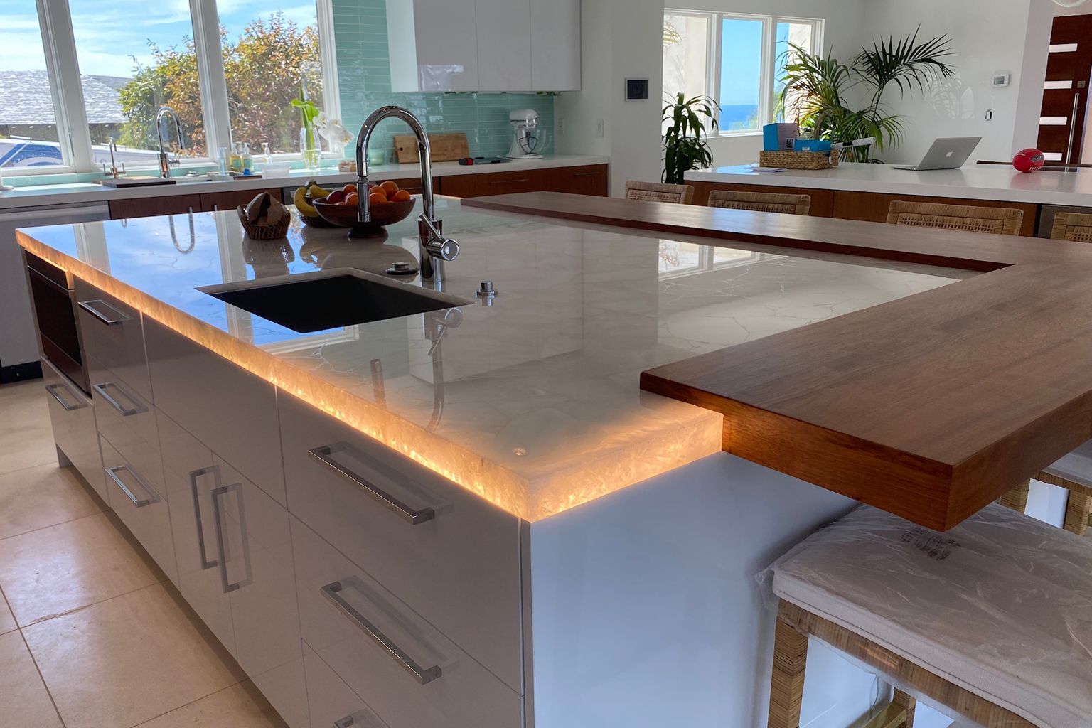 A kitchen with a large island and a sink.