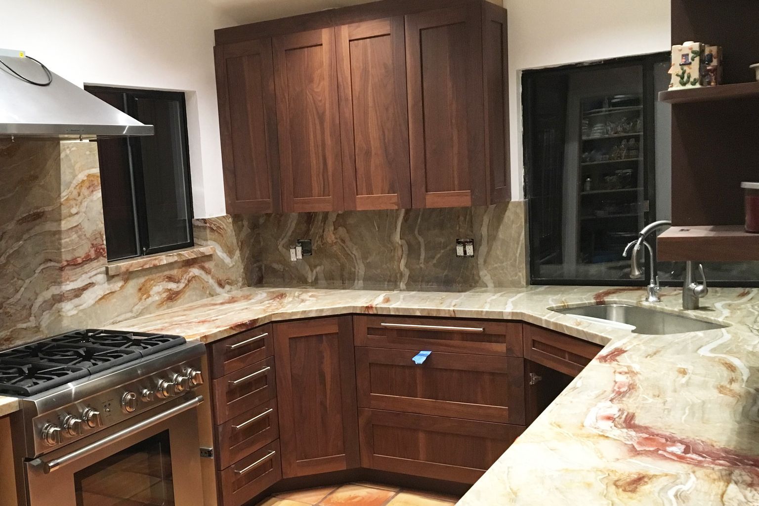 A kitchen with wooden cabinets and granite counter tops