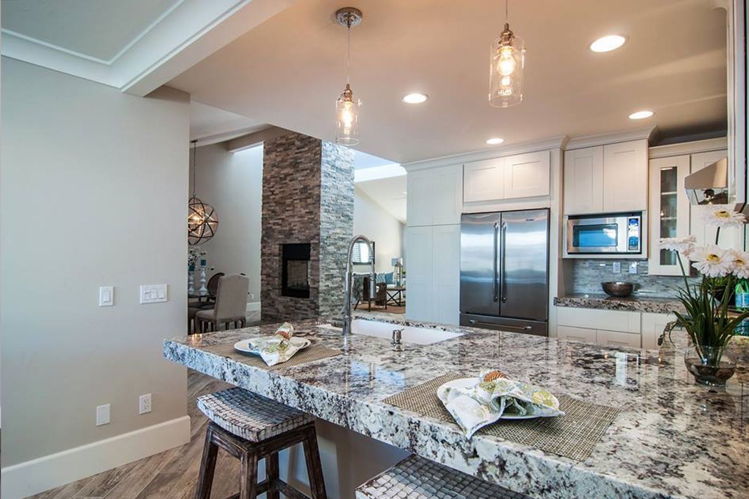 A kitchen with granite counter tops and stainless steel appliances in San Diego.