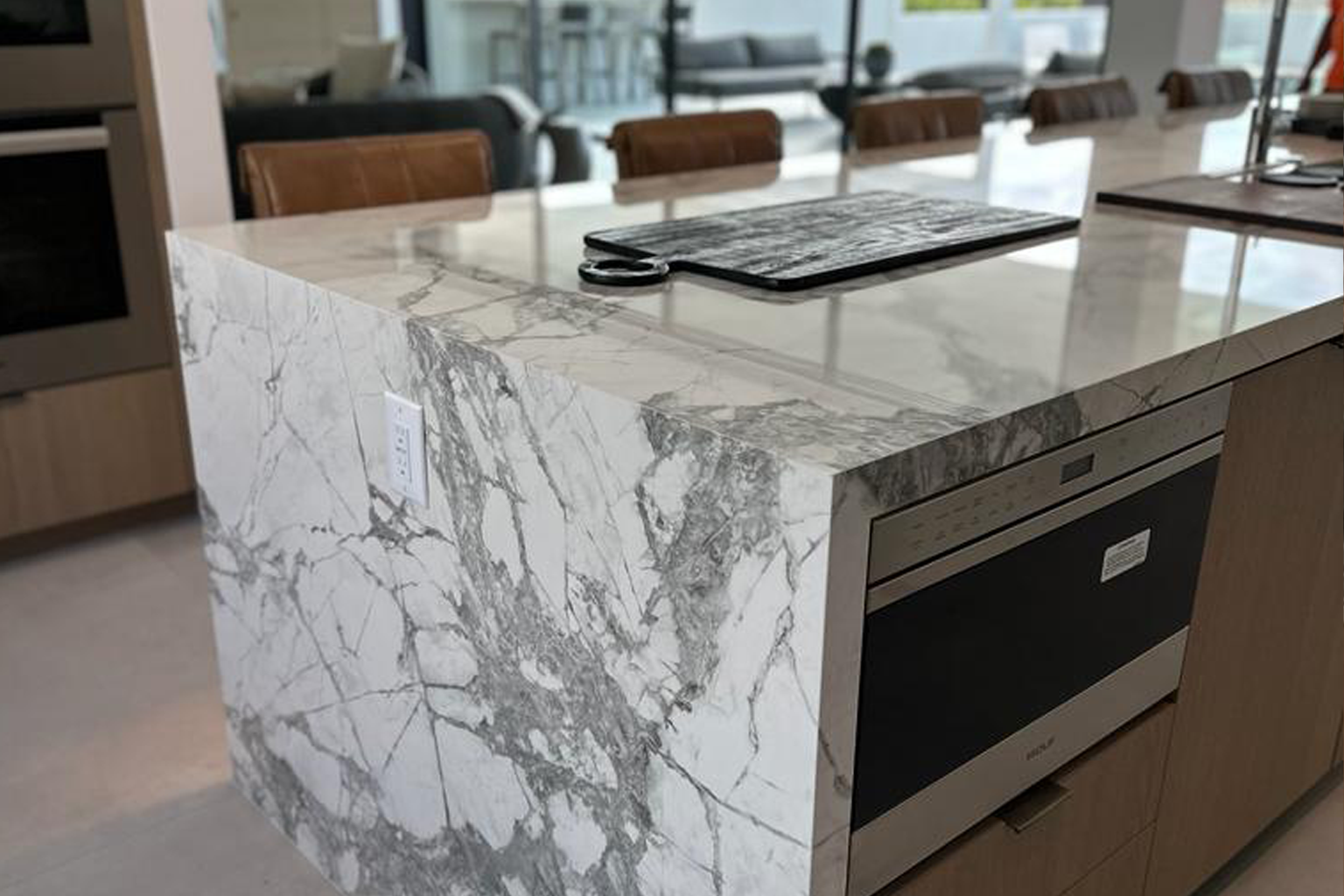 A kitchen with a marble counter top and stainless steel appliances in San Diego.