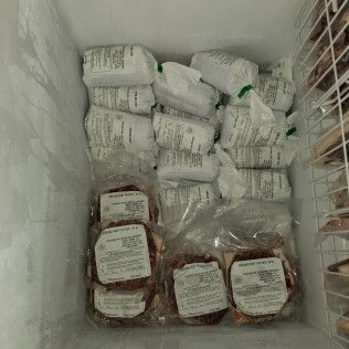 A freezer filled with lots of bags of food.