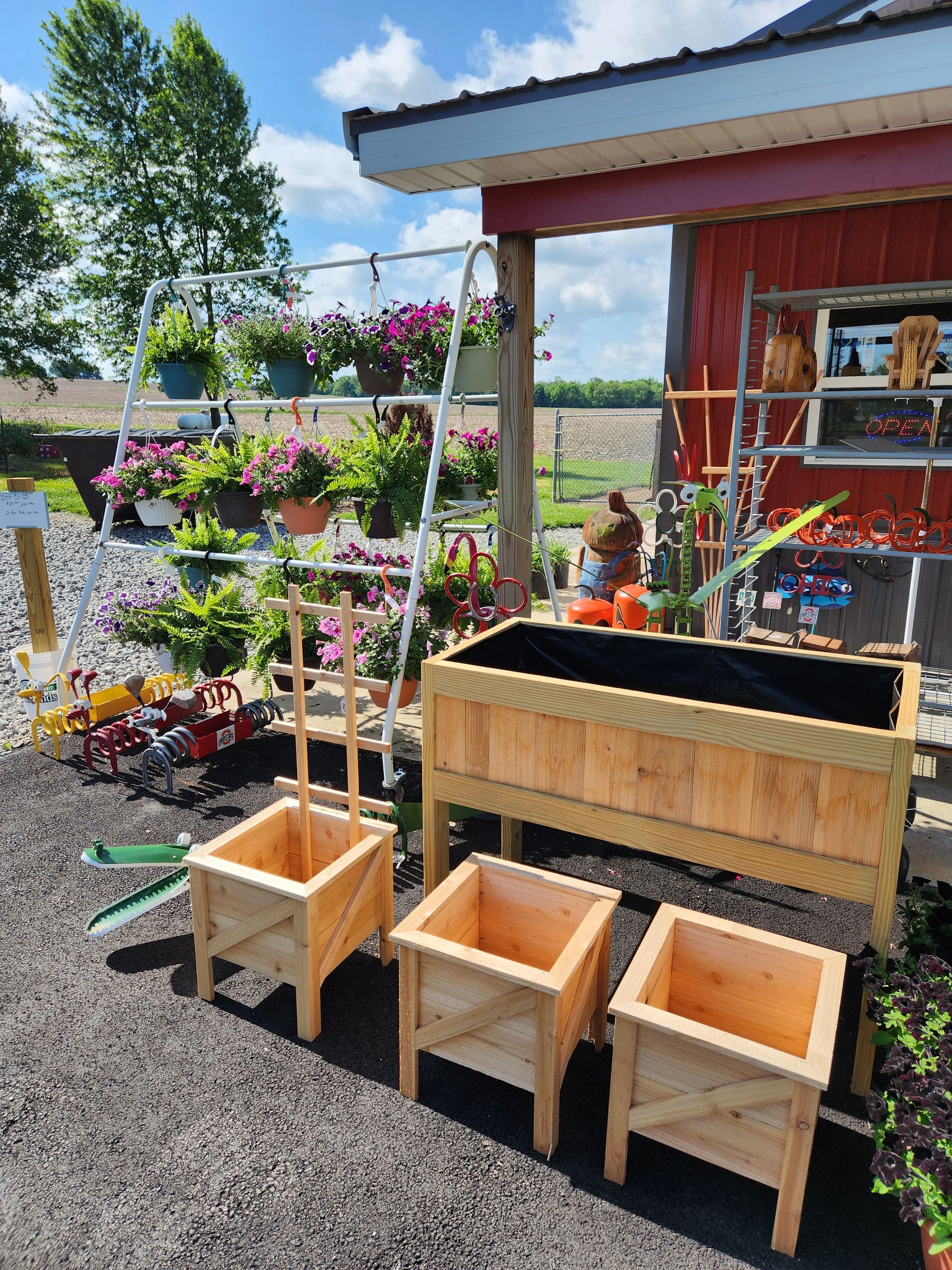 A row of wooden planters in front of a red building