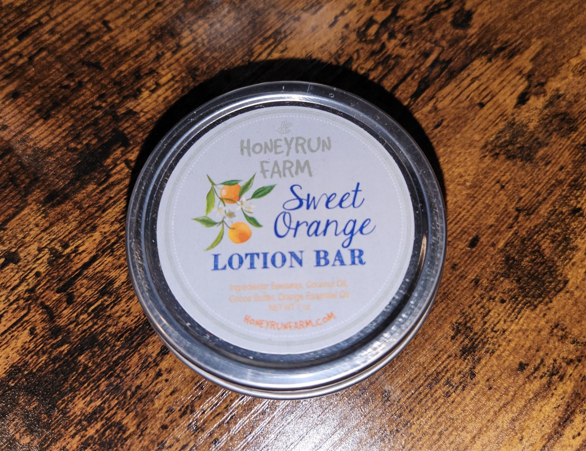 A sweet orange lotion bar is sitting on a wooden table