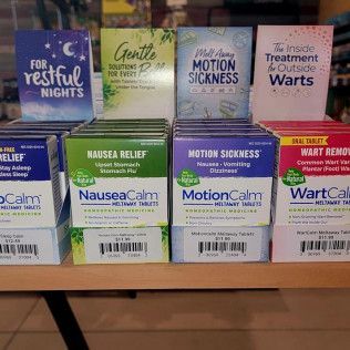 A shelf filled with boxes of motion sickness pills.