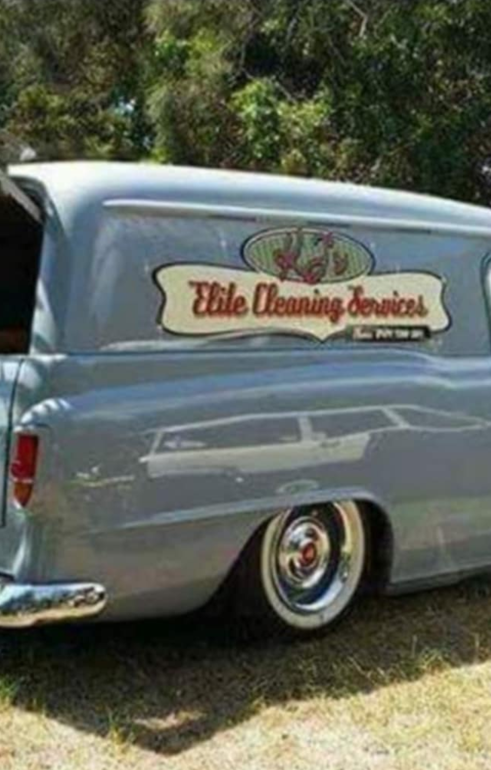 A Woman Is Cleaning a Couch with A Vacuum Cleaner — KJ's Elite Cleaning Services Newcastle in East Maitland, NSW