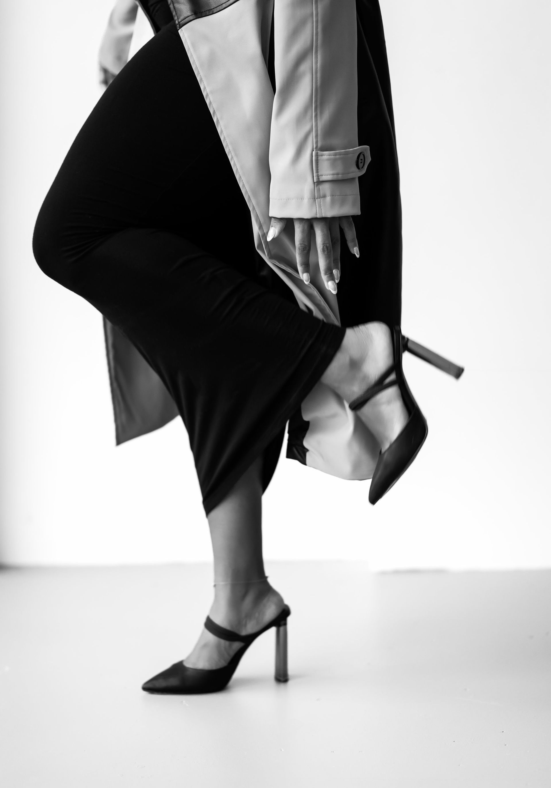 A black and white photo of a woman wearing high heels