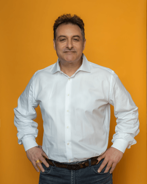 Toronto Greektown business owner standing with hands at hips for headshot photo