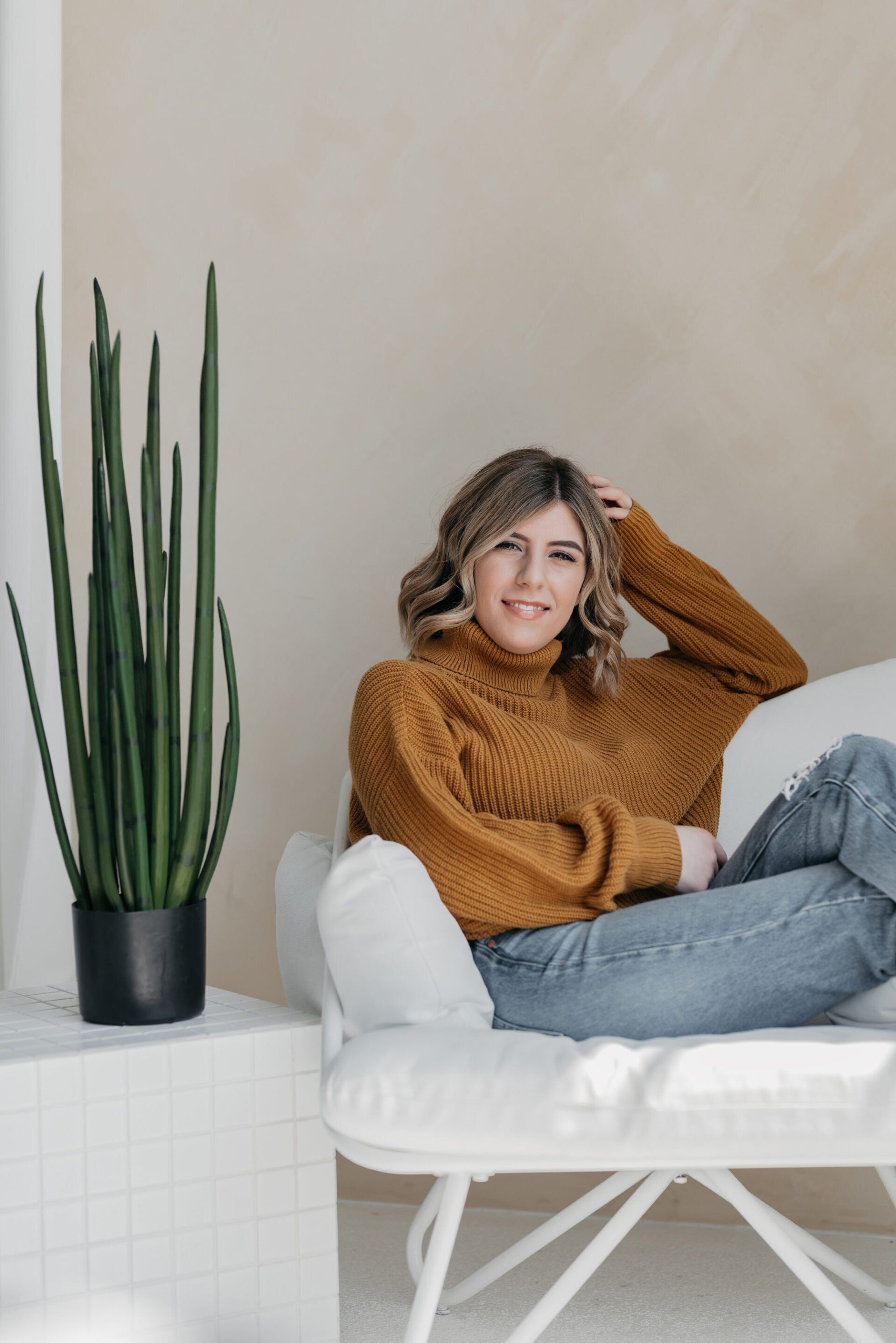 Photo of a smiling female business owner lounging in a chair
