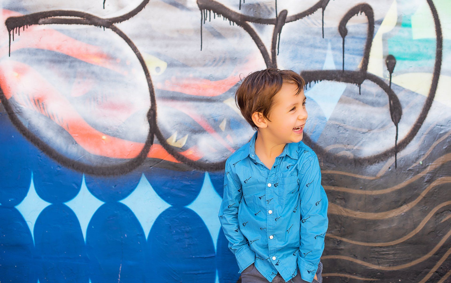 Boy in front of graffiti-covered wall | Child photography | Stacey Naglie Toronto