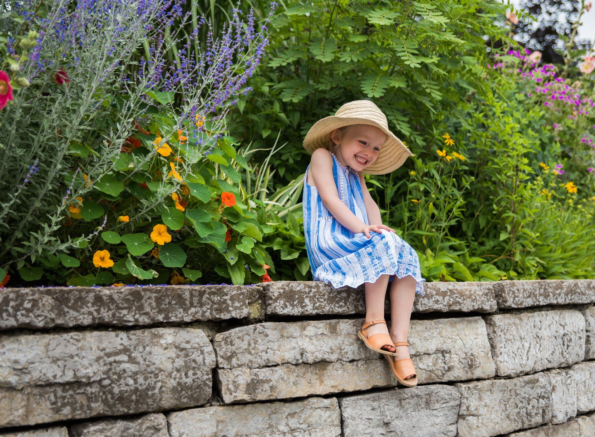 Young girl sitting on stone wall | Child photography | Stacey Naglie Toronto