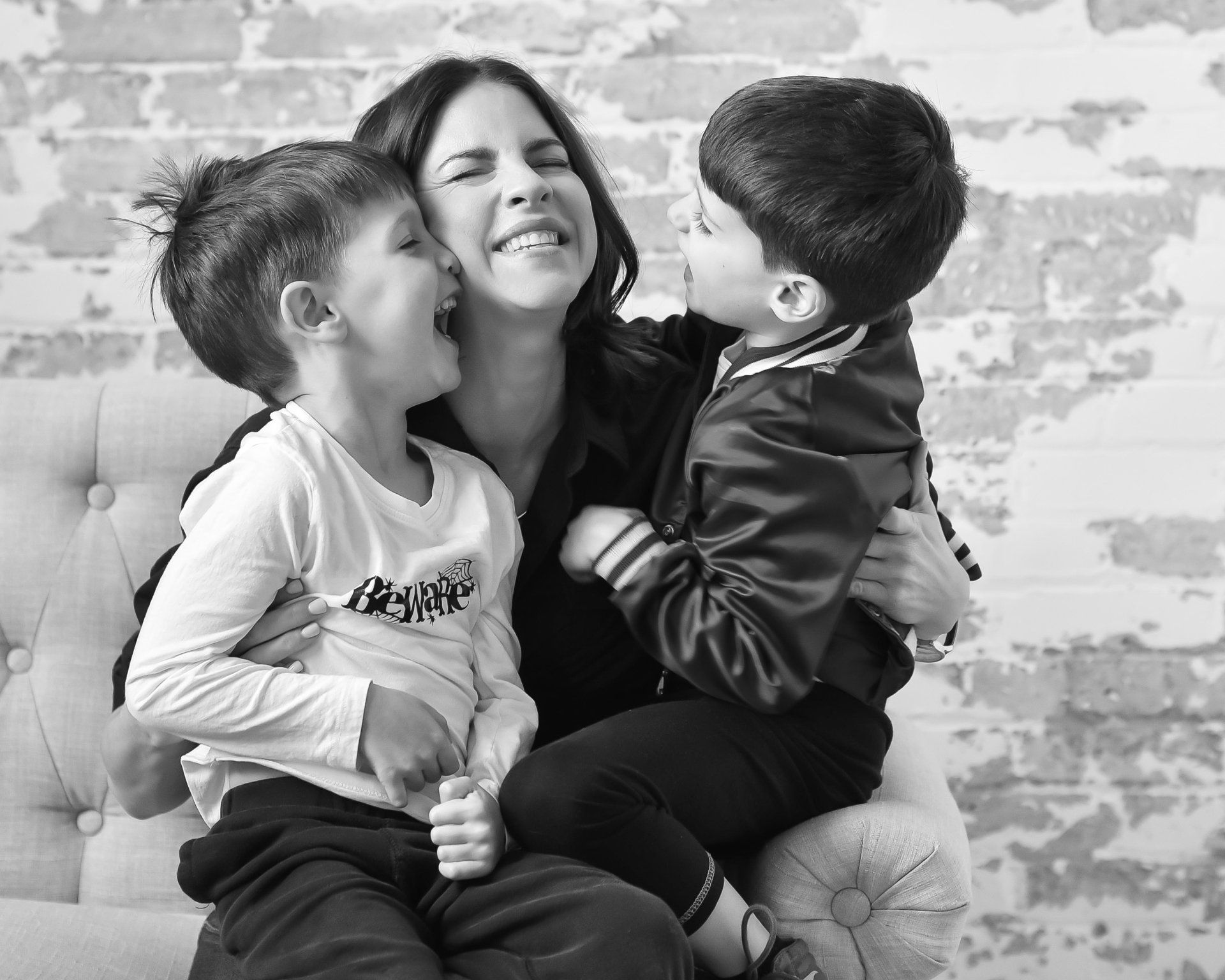 Lifestyle photography at home Toronto | Stacey Naglie | Woman holding two laughing boys in her lap