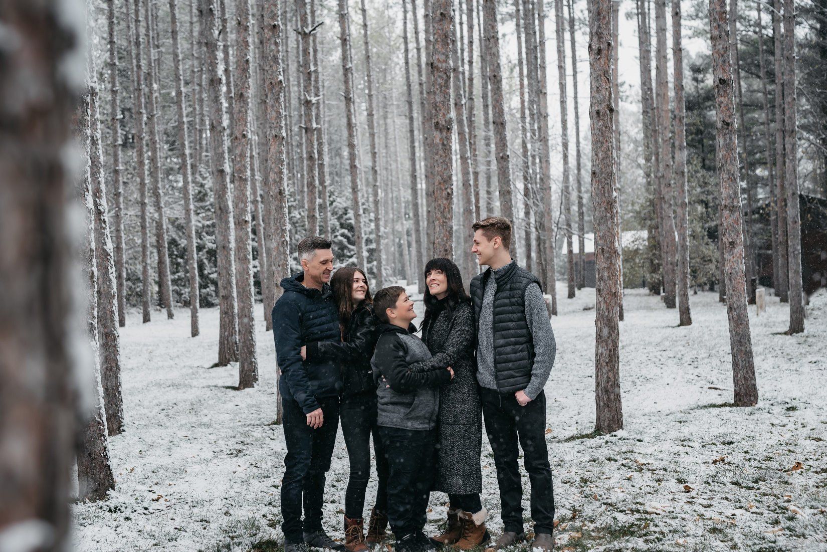 Photo of a Toronto family in snow covered woods for family photography