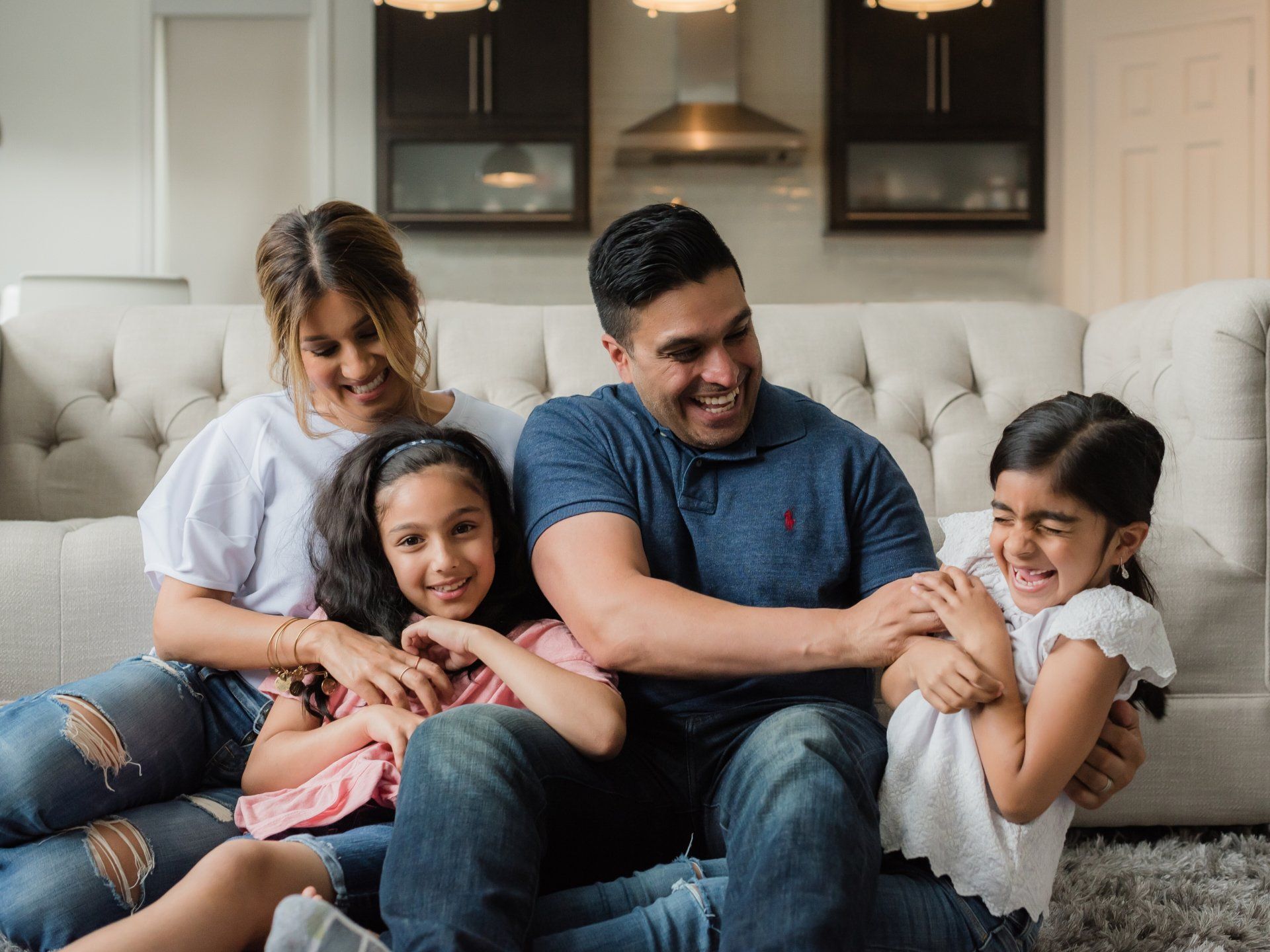 Photo of a smiling family sitting in their living room for toronto gift idea