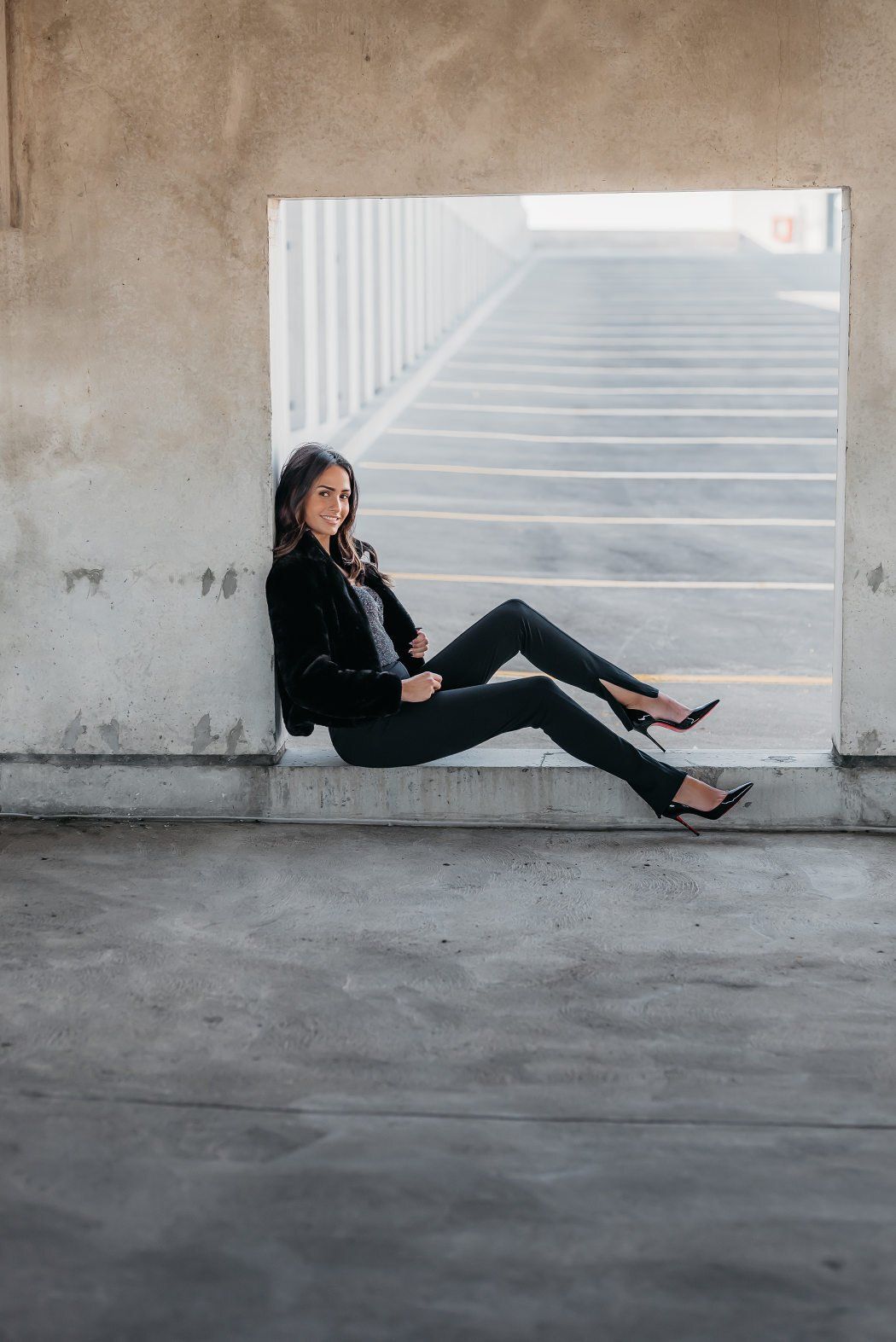 Social influencer Chantel in a casual black outfit sitting on concrete floor