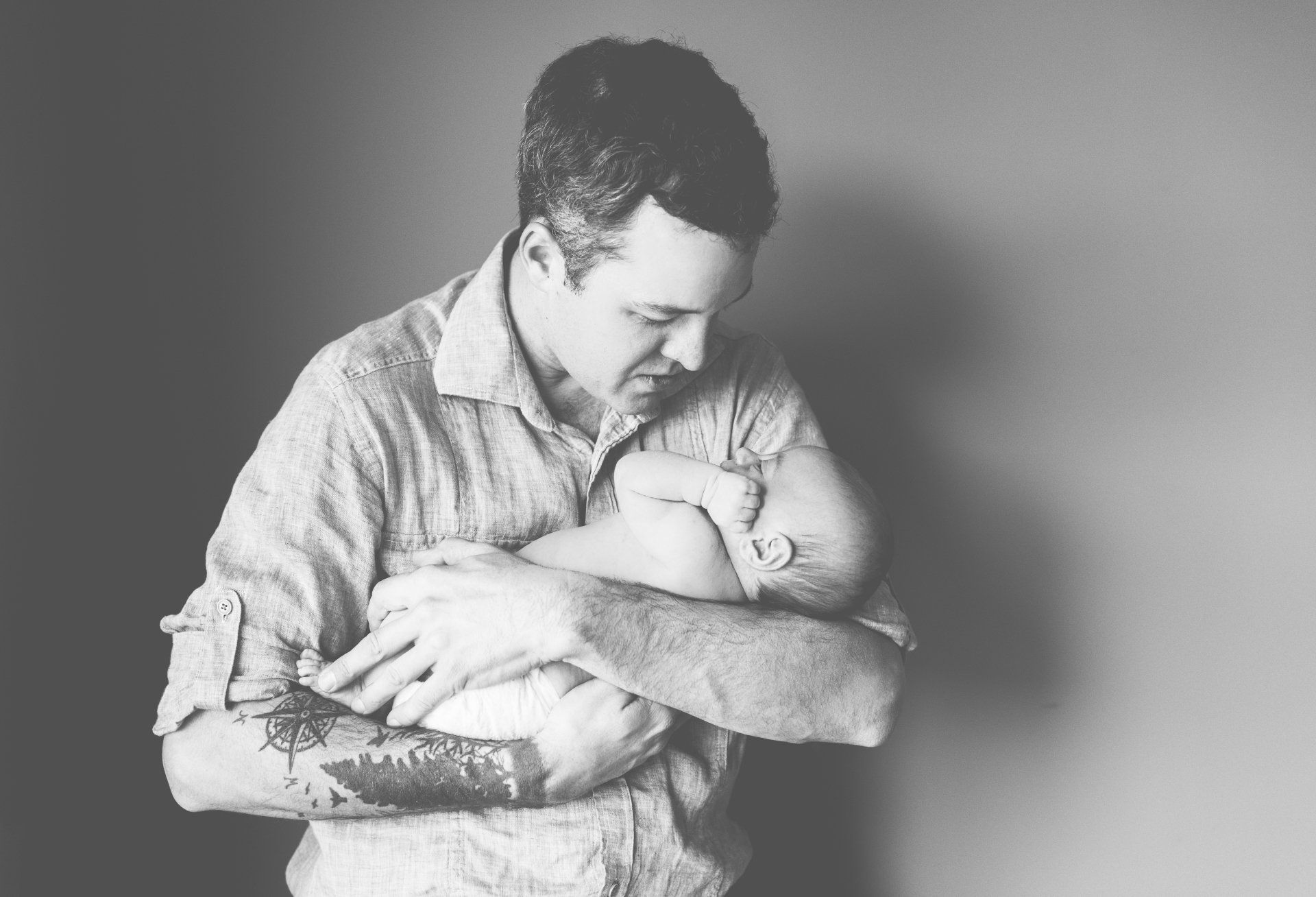 Newborn photography Toronto | Stacey Naglie | Man cradling baby in his arms